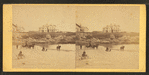 Coaches, horseback rider and people on the beach and houses in the distance.