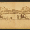 Children in goat cart on beach.