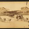 Children in goat cart on beach.