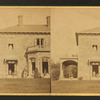 Family posing in front and in the porch of Stone House.