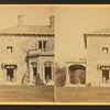 Family posing in front and in the porch of Stone House.