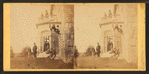 Family posing in front and in the balcony of stone house.