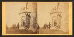 Family posing in front and in the balcony of stone house.