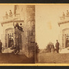 Family posing in front and in the balcony of stone house.