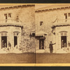 Family posing in front and in the balcony of stone house.