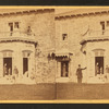 Family posing in front and in the balcony of stone house.