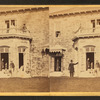 Family posing in front and in the balcony of stone house.