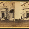 Family posing in front and in the balcony of stone house.