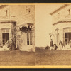 Family posing in front and in the balcony of stone house.