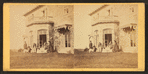 Family posing in front and in the balcony of stone house.