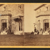 Family posing in front and in the balcony of stone house.