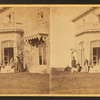Family posing in front and in the balcony of stone house.