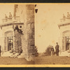Family posing in front and in the balcony of stone house.