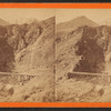 Devil's Gate from the south, the high peaks of the Wahsatch [Wasatch] in the distance. Union Pacific Railroad.
