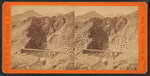 Devil's Gate from the south, the high peaks of the Wahsatch [Wasatch] in the distance. Union Pacific Railroad.