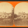 People posing in front of the house with fences.