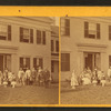 A group in front of a wood frame home or hotel, Brattleboro, Vt.