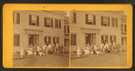 A group in front of a wood frame home or hotel, Brattleboro, Vt.