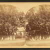 Group of women in front of house (identified on verso).