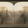 Reclaiming swamp land. Digging ditch with tractor, and laying drain tile, Wisconsin.