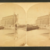 View of an elevator, with ships moored at levee.