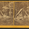 Indian camp in Maine, [showing family group sitting in front of tent].