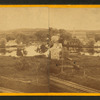 View of unidentified industrial buildings on a river.