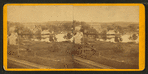 View of unidentified industrial buildings on a river.