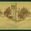 View of a residential street with houses and a buggy.