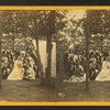 Group portrait at a camp in the woods.