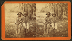 Happy little nig's. [Two boys sitting on a barrel in a field.]