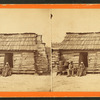 Uncle Ben's cabin. [Elderly couple sitting in front of a cabin.]