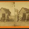 Man in a top hat in front of a shack with several boys with books.