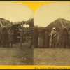 Group of Indians and mud lodge in Pawnee village.