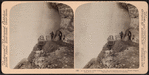 An old Niagara guide, looking into the awe-inspiring Cave of the Winds, Niagara Falls, U.S.A.