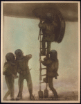 Divers descending from the submarine.