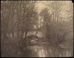Stone bridge seen through trees