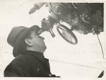 Moe Berg looking in an artillery gun sight