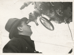 Moe Berg looking through a telescope