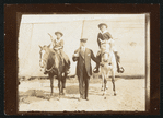 William F. Cody, right, on horseback with unidentified others