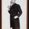 William Gillette, in the role of Sherlock Holmes, lighting a cigarette
