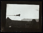 Harry Houdini suspended upside down in a bag from a building roof