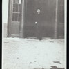 Harry Houdini standing in front of a theatre or shop entrance