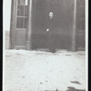 Harry Houdini standing in front of a theatre or shop entrance