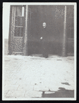 Harry Houdini standing in front of a theatre or shop entrance