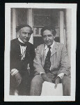 Harry Houdini and Howard Thurston sitting on a porch, possibly at Thurston's home in Beechhurst, Queens, N.Y.