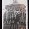 Harry Houdini and unidentified man standing in front of  a garden gazebo