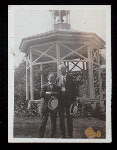 Harry Houdini and unidentified man standing in front of  a garden gazebo