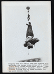 Harry Houdini suspended upside down in a straightjacket