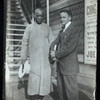 Harry Houdini with Ching Ling Foo outside the Brighton Beach Music Hall, with promotional poster behind